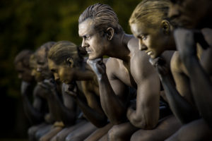 Nine models posed as Rodin's Thinker